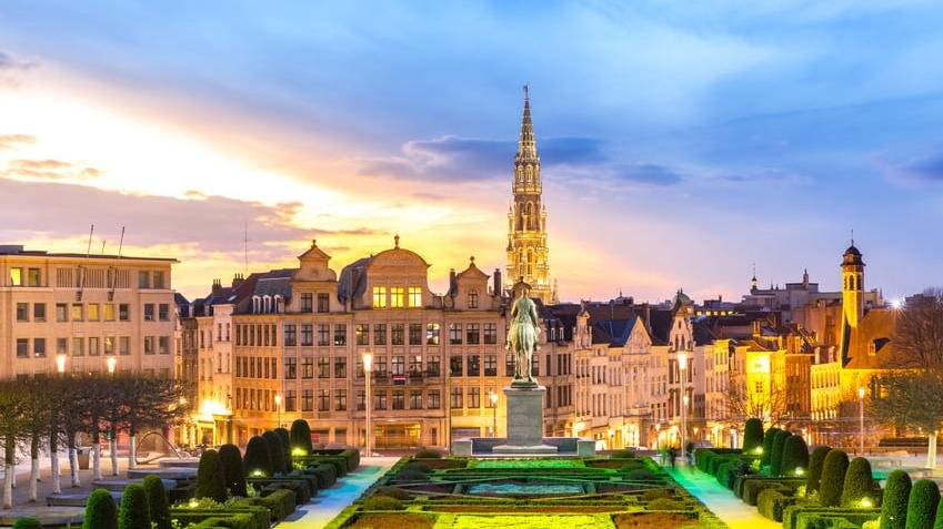 Panoramic view of Brussels city center with historic architecture and gardens at sunset